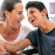 2022 KIDS COUNT Data Book: mentally challenged boy laughing with guardian at table