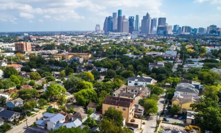 guide to reduce youth gun and gang/group violence: photo of city skyline in background and communities in foreground on a partly-cloudy day