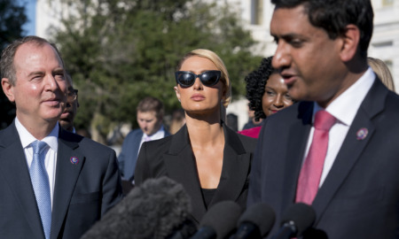 Troubled teen industry press conference - A person in a black suit, a person in sunglasses and black top, a person in a black suit