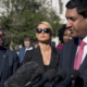 Troubled teen industry press conference - A person in a black suit, a person in sunglasses and black top, a person in a black suit