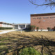 Mississippi afterschool programming: Red brick buildings under clear blue sky with school name signage