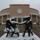 New Mexico passes new child protection law: statue of children playing outside New Mexico state Capitol in the snow