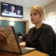 Online SAT: A person with blonde hair sits next to a laptop