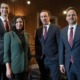 Social media ban for kids in Senate: three men and a woman in a suit inside government building standing and smiling at camera