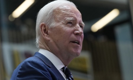 Biden executive order child care access: old white man with white hair looks up and to the right while speaking