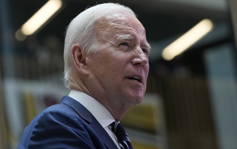 Biden executive order child care access: old white man with white hair looks up and to the right while speaking