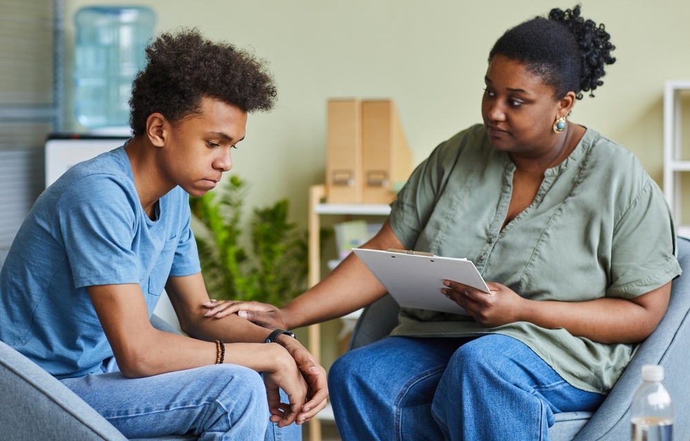 Black youth mental health and suicide: Black teen being helped by black woman psychologist