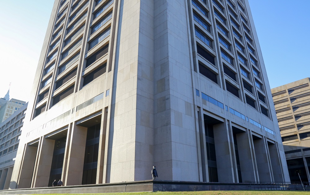 Can Cleveland reduce harm eviction does to Black families: image of person standing in front of large, imposing building from far away