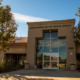 A tan building with the label Corona-Norco Unified School District