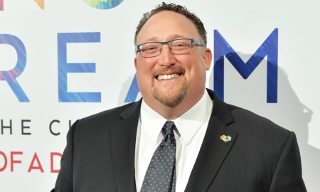 David Shapiro newsmaker: smiling man with goatee and glasses in suit at event