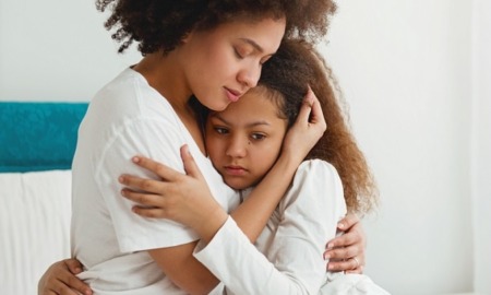 children exposed to violence, family violence grants: mother comforting her young, sad daughter