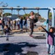 education research grants: kids playing on swingset on sunny day