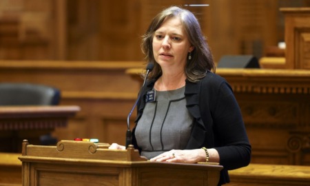 Georgia Senate bans some transgender care for youth: white woman with brown hair speaks into mic at podium