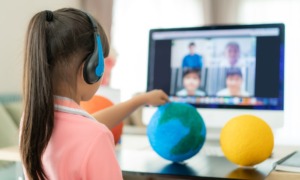 Asian girl student live learning video conference with teacher and other classmates giving presentation, showing solar model project