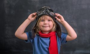 STEM education, aviation and aerospace K-12 education grants: Happy smiling kid in glasses and red scarf ready for education