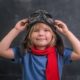 STEM education, aviation and aerospace K-12 education grants: Happy smiling kid in glasses and red scarf ready for education