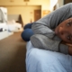 homeless youth transitional living program grants: young black woman lying on bed in shelter