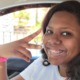 Special ed diagnosis problems: teen black girl showing peace in car seat