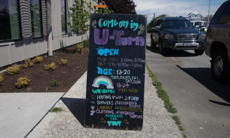 Bright chalkboard sign on sidewalk.