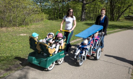 Minnesota expands public funding for childcare: two women in park with lots of small children in strollers