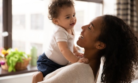 child health, maternal health grants: young black mother and child smiling and laughing