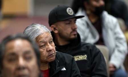 Native Americans share trauma of Arizona boarding schools: row of people sitting and looking off to the side