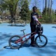 New BMX program teaches North Tulsa kids about bikes, racing and resilience: young black kid poses with his BMX bike outdoors