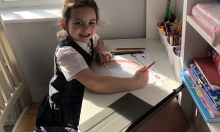 Some disabled students and parents want remote learning permanent option: little girl doing school work at home desk with tablet