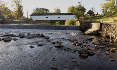 Appalachian Parks Program: Whtie covered bridge surrounded by green trees sits crosses river in Elizabethton TN