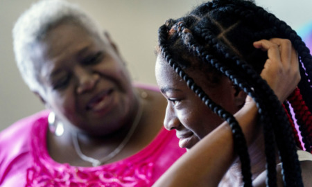 Social security: AN older silver-haired Black woman and younger Black woman with black hair