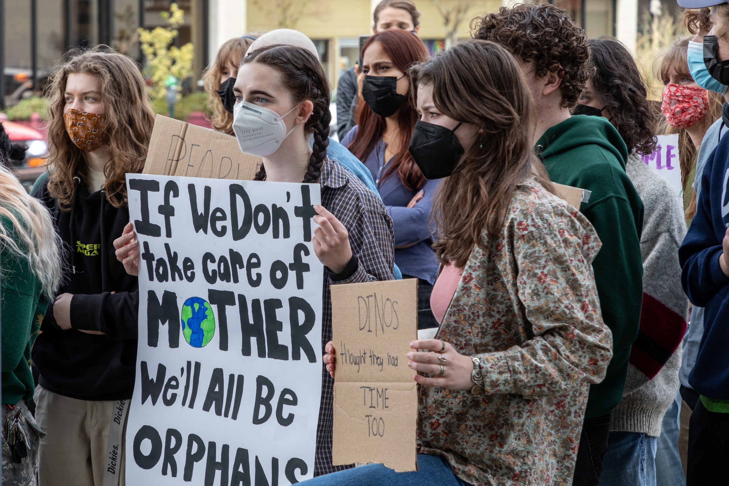 Climate change series: Young people hold protest signs