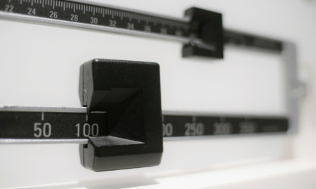 Childhood obesity: closeup of a beam scale