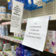 Children's Medicine shortage: Store shelves stocked with childremn's medicine and signs about buying limits and out of stock