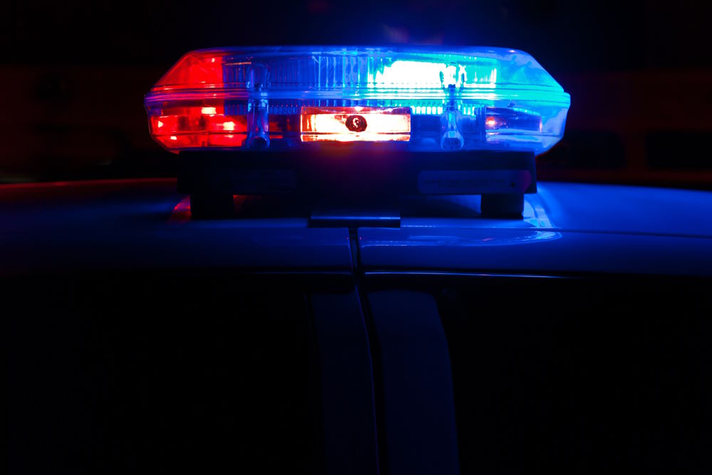 Police and Foster Care: Close-up of red and blue light on top of car roof