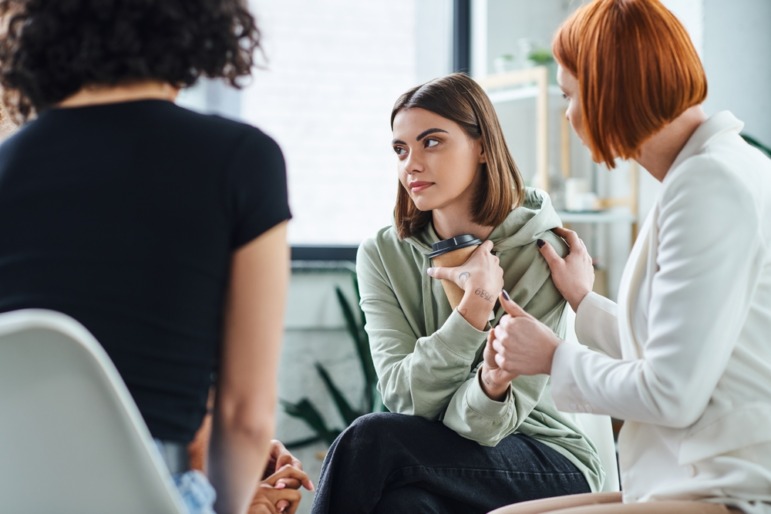 Autistic students college success tips: A few college students sit in a close circle with a counselor.