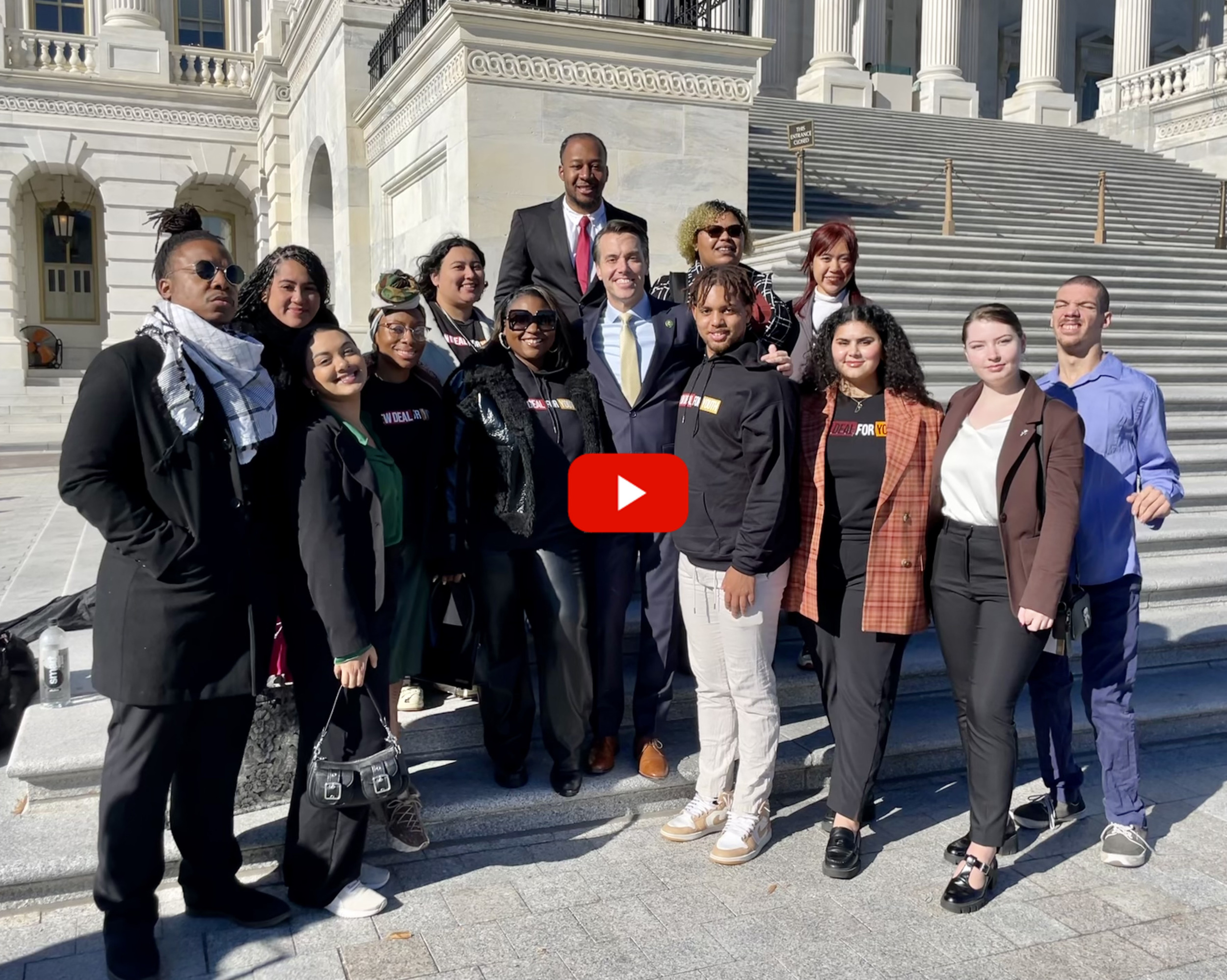 Youth Adult Tax Credit: Group of several people stand together in two rows on steps of large white cement building with white pillars