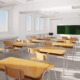 Louisiana school funding: Empty white classroom with rows of light wood desks and chairs facing a blackboard.