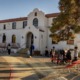 Native American charter schools: Adobe Spanish style off-white, 2-story large building