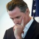 Newsom's aboutface raises homelessness risks for California's oldest foster care youth: white man in suit with head in hand looking down