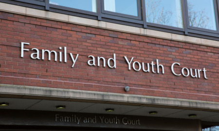 Teen court: Red brick building with close-up of sign in silver letters reading "Family and Youth Court""