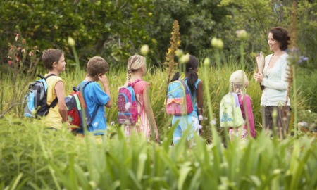 outdoor learning grant: teacher and students in backpacks out in nature