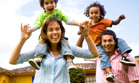 Report family dynamics: happy family portrait having fun outdoors at their home