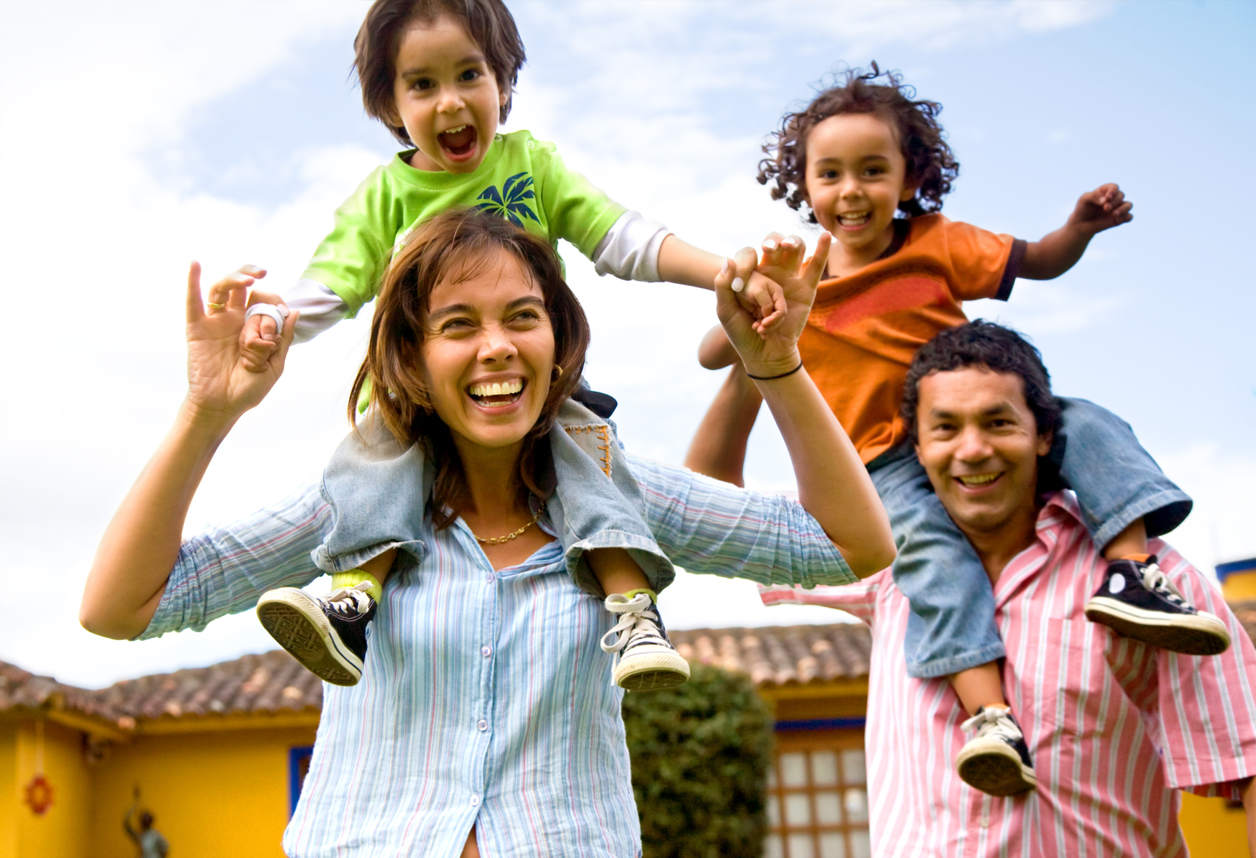 Report family dynamics: happy family portrait having fun outdoors at their home