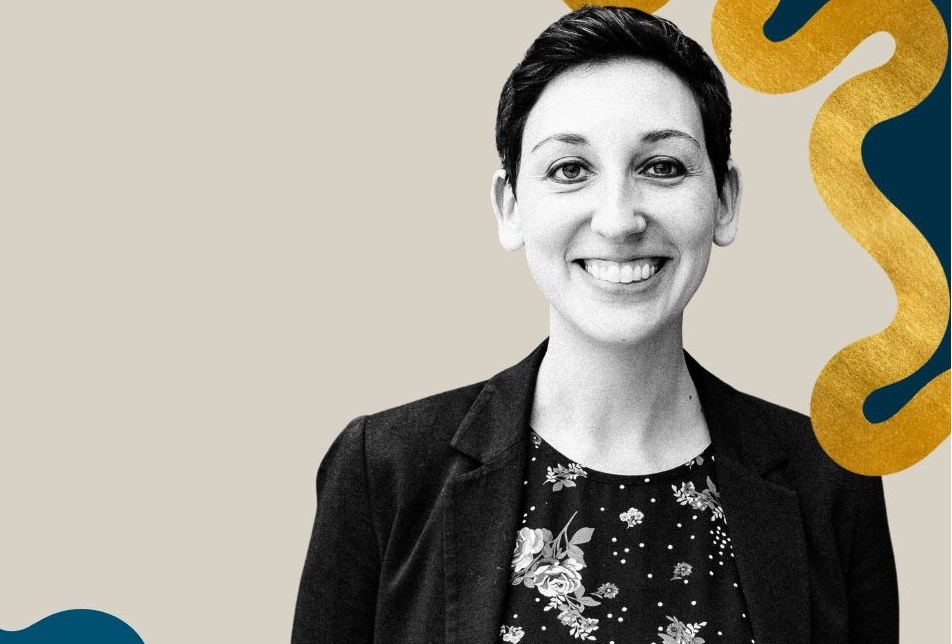 Shawna Rosenzweig president of Camp Fire: woman with short, dark hair smiling in front of graphic grey and colorful background