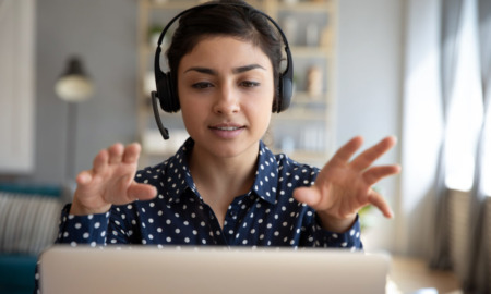 5 questions to ask when hiring consultant: young woman with headset talking on computer