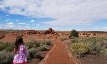 Native American: A child walking down a path to view ruins.