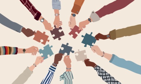 Alternatives to prison: Group of multicultural arms an hands forming circle reaching to each other with multi-colored puzzle pieces