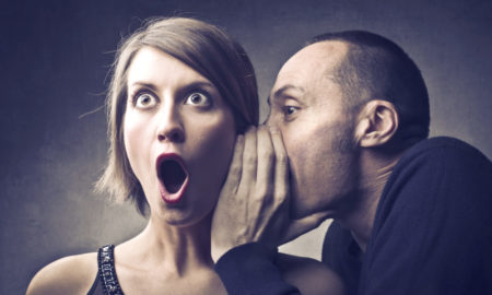 fundraising secret: man whispers into the ear of woman with shocked expression on her face