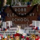 State's plans to make school safer political divides: Robb Elementary School sign with memorial made on and around it