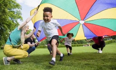 The state of preschool 2022: children playing under colorful circle tarp